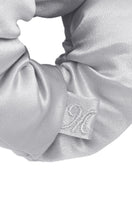 Set of puff hair scrunchies in gray, black, pink, and white by MANITO, featuring soft, textured fabric for stylish hair accessories.