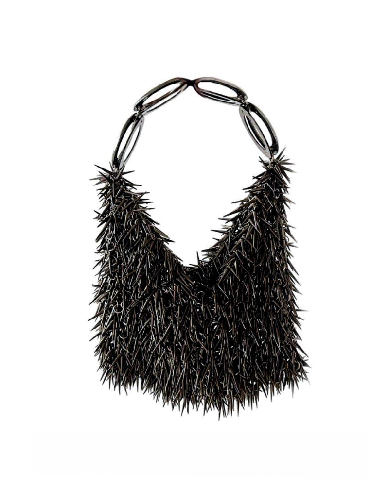 Millanne Tale punk silver top handle bag with sleek design, shown against a white background.