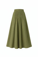 Olive drab midi skirt by ANA + MARIA, featuring a flowy fabric and stylish design in a natural outdoor setting.