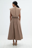 Camel midi skirt by ANA + MARIA featuring a flowing silhouette and stylish design, shown on a neutral background.
