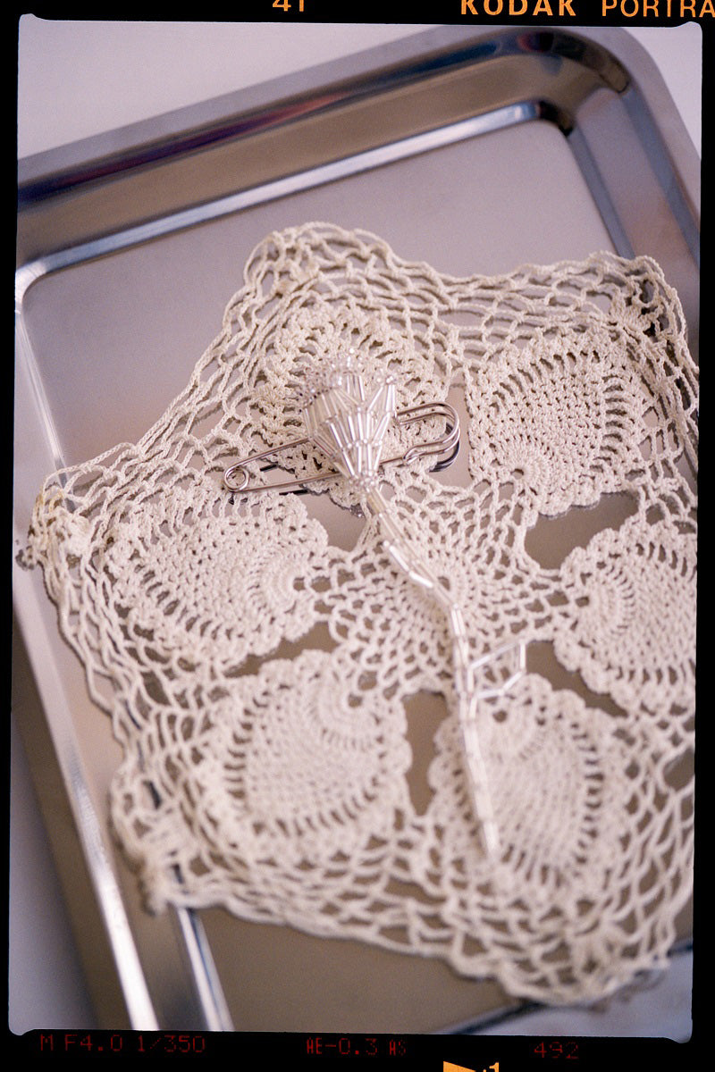 Silver tulip brooch body jewelry by Pura Utz featuring a delicate floral design in polished silver.