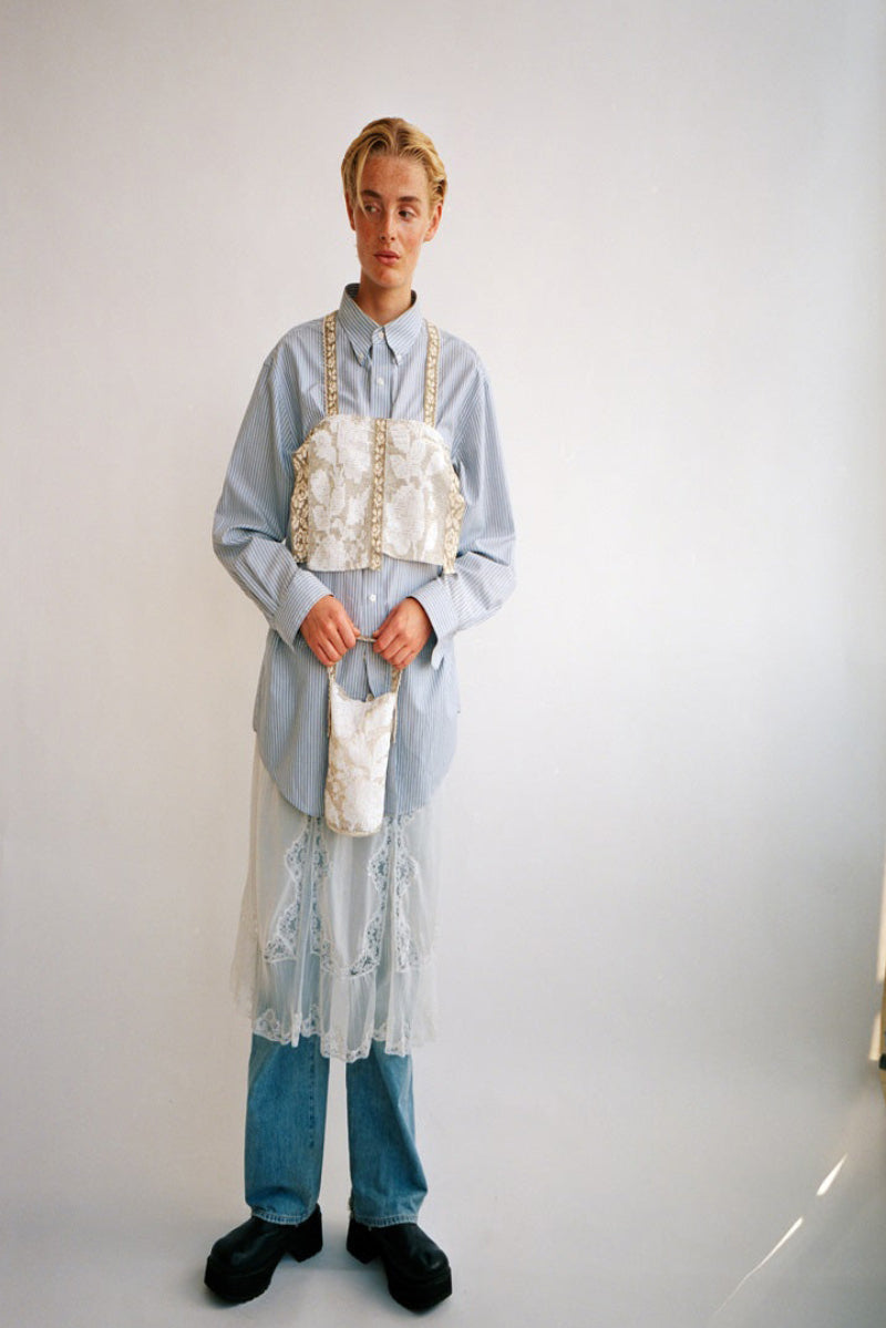 Silver lace top by Pura Utz featuring intricate lace details and a stylish fit, perfect for modern fashion statements.