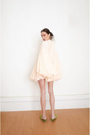Back view of YASSMIN SALEH Quietude Ivory Mini Dress showcasing its elegant design and lightweight fabric.