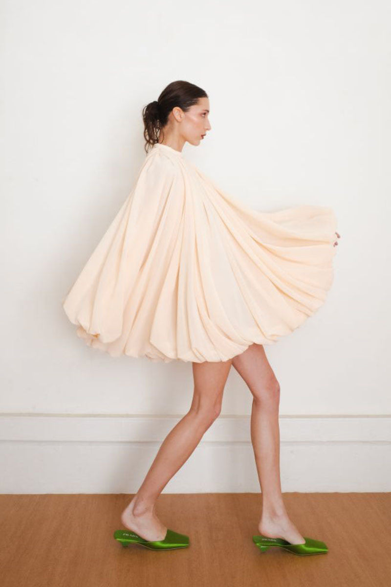 Side view of YASSMIN SALEH Quietude ivory mini dress, showcasing its elegant fit and stylish design.