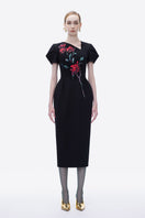 Hand-painted black Blossom Noir midi dress by Tiny Ink, featuring elegant flowy fabric and detailed floral artwork.