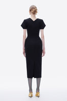 Hand-painted black Tiny Ink Blossom Noir midi dress displayed on a hanger with detailed floral artwork and flowing fabric.