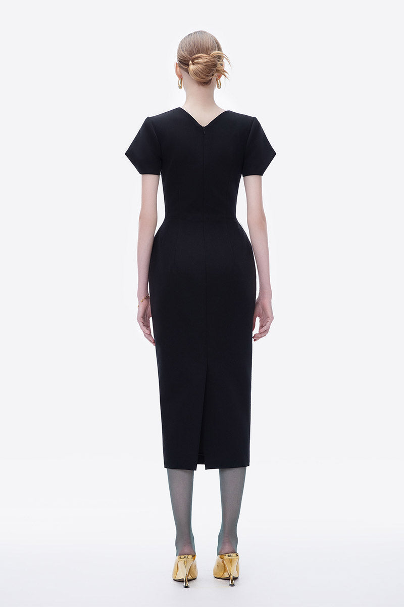 Hand-painted black Tiny Ink Blossom Noir midi dress displayed on a hanger with detailed floral artwork and flowing fabric.