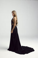 Black VEYA gown by Francisco Arce featuring elegant fabric and a flowing silhouette, perfect for formal occasions.
