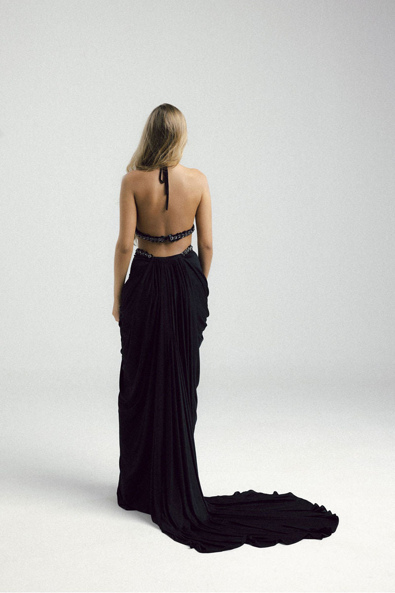 Black VEYA gown by Francisco Arce featuring elegant design, flowing fabric, and sophisticated style.
