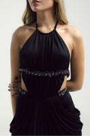 Black VEYA gown by Francisco Arce featuring elegant fabric and a flowing design, showcased on a model.