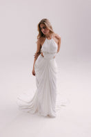 Elegant white gown by Francisco Arce, featuring flowing fabric and intricate design, perfect for formal occasions.