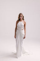 Elegant white VEYA gown by Francisco Arce, featuring flowing fabric and intricate detailing, perfect for formal occasions.