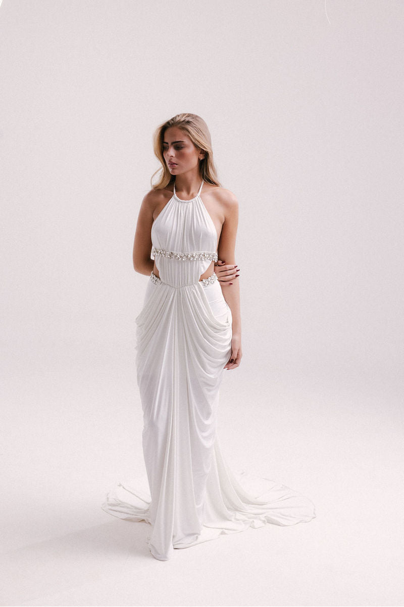 White VEYA gown by Francisco Arce, elegant floor-length dress with flowing fabric and sophisticated design.
