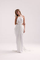 Elegant white VEYA gown by Francisco Arce, featuring flowing fabric and sophisticated design for formal occasions.