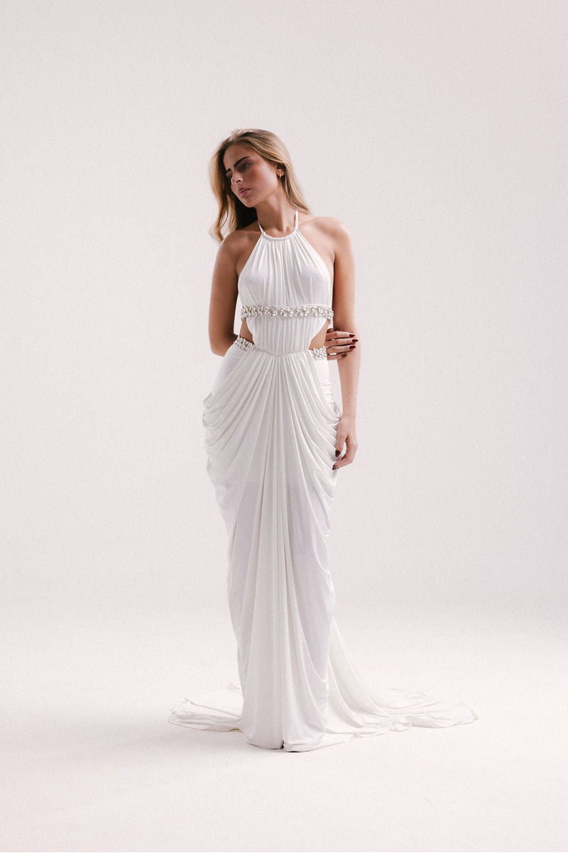 Elegant white VEYA gown by Francisco Arce, featuring flowing fabric and sophisticated design for formal occasions.