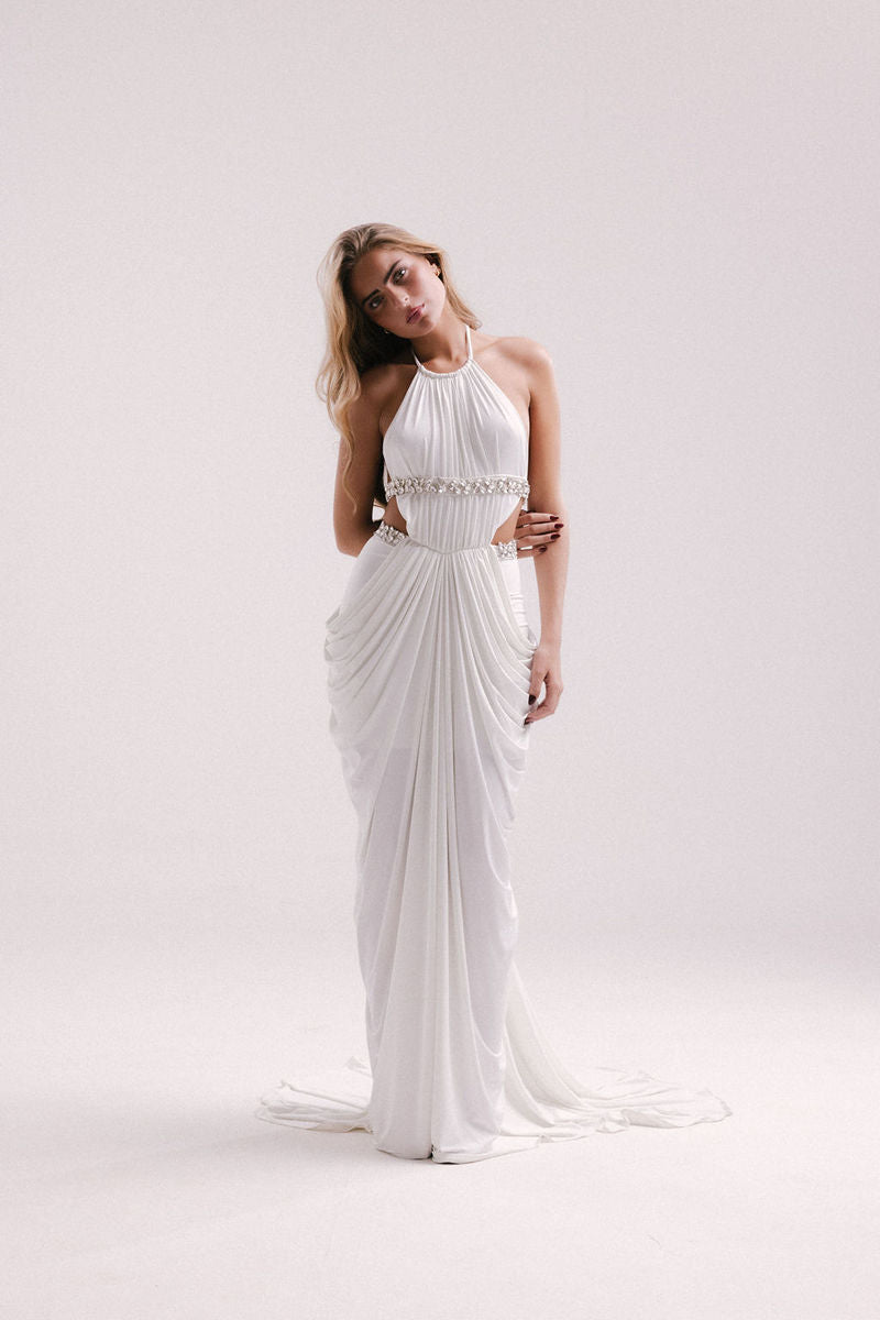 Elegant white Veya gown by Francisco Arce, featuring flowing fabric and sophisticated design for formal occasions.