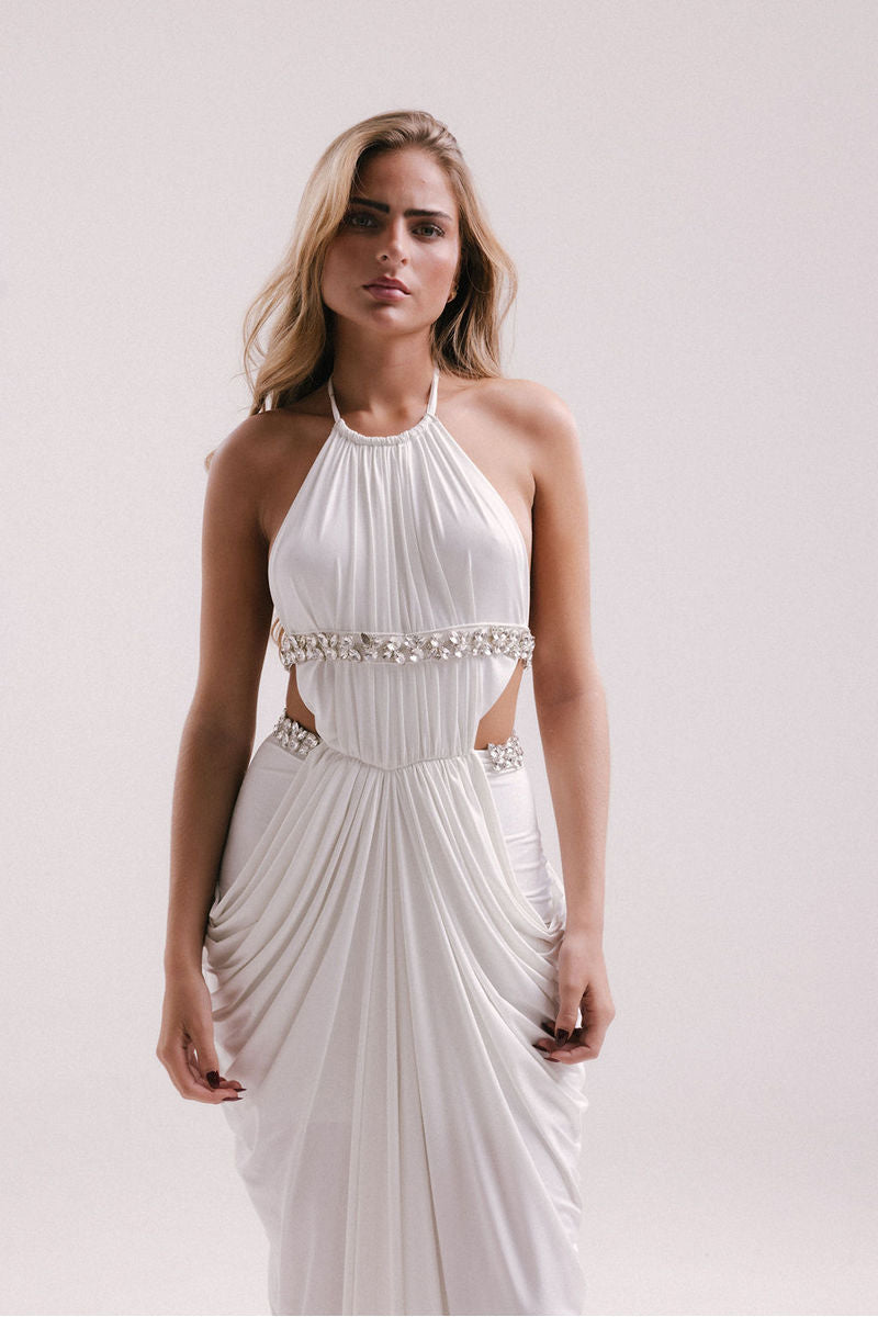 Elegant white VEYA gown by Francisco Arce, featuring flowing fabric and stylish design, perfect for formal occasions.
