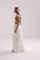 White Veya gown by Francisco Arce featuring elegant fabric and a flowing silhouette, perfect for formal occasions.