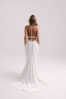 Elegant white gown by Francisco Arce, showcasing a flowing design with intricate details for formal occasions.