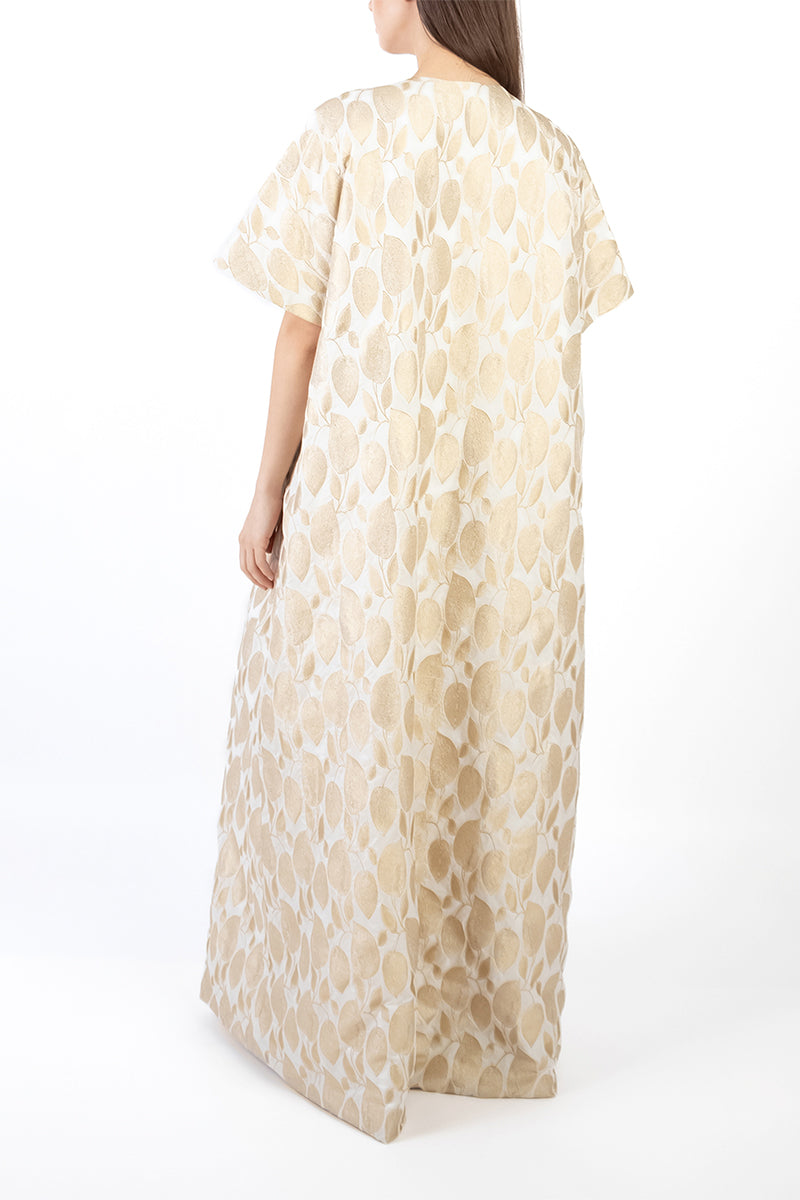 Back view of a gold coat dress by Shatha Essa, featuring a stylish, elegant design perfect for formal occasions.