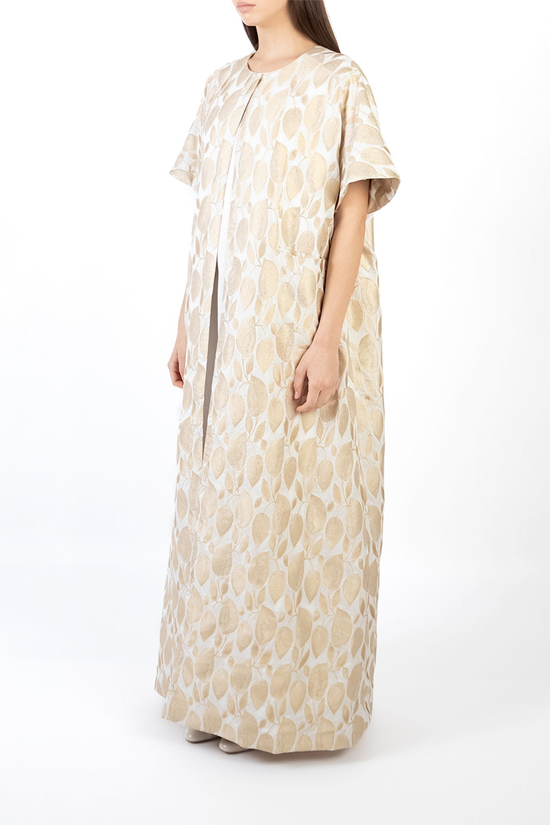 Side view of a gold coat dress by Shatha Essa, showcasing elegant design and stylish fit.