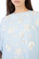 Light blue floral embellished maxi dress by Shatha Essa with intricate embroidery and flowing fabric, perfect for elegant occasions.