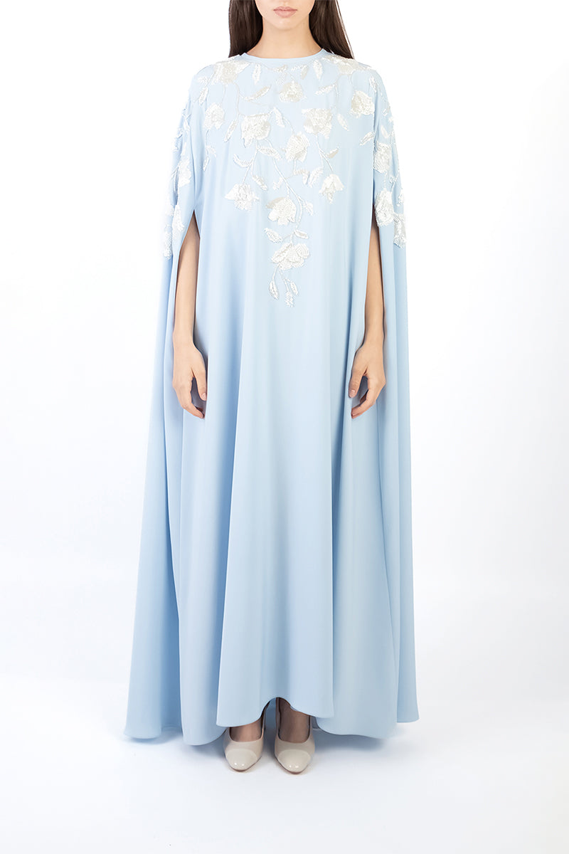 Light blue floral embellished maxi dress by Shatha Essa, front view showcasing intricate floral details and elegant design.
