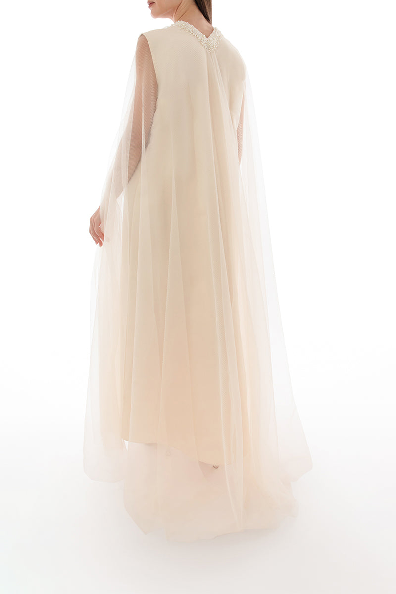Back view of Shatha Essa pearl-embellished drape detail gown with elegant cape design.