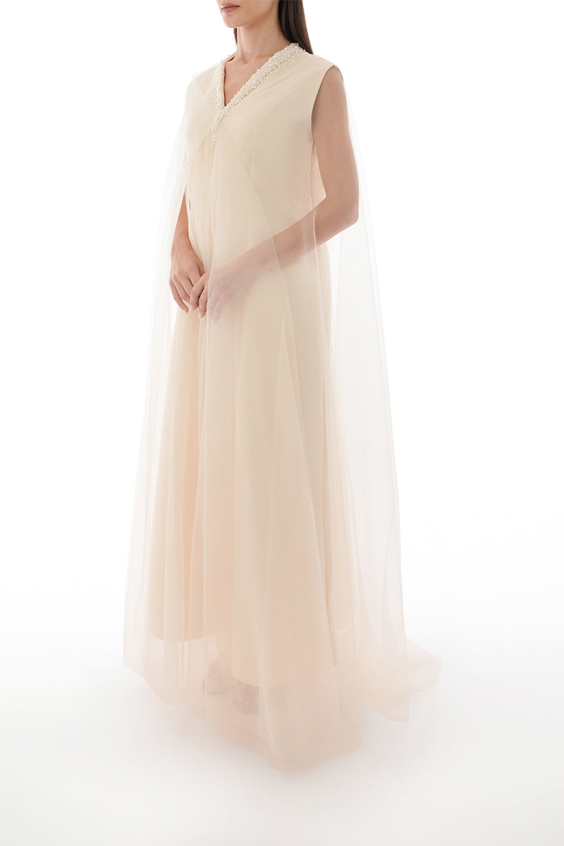 Side view of a pearl-embellished drape detail cape gown by Shatha Essa, showcasing elegant design and luxurious fabric.