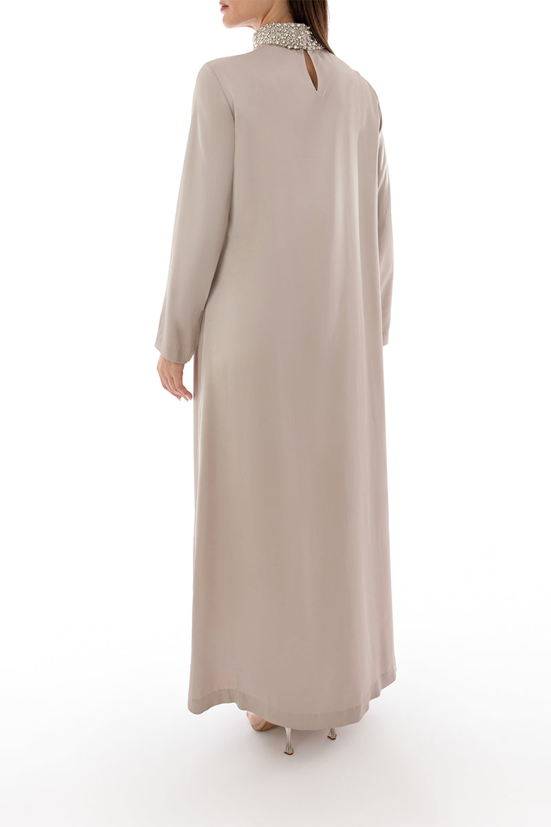 Back view of Shatha Essa crystal-embellished collar detail maxi dress, showcasing elegant design and flowing fabric.