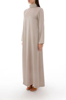 Side view of a SHATHA ESSA crystal-embellished collar detail maxi dress with elegant design and flowy fabric.