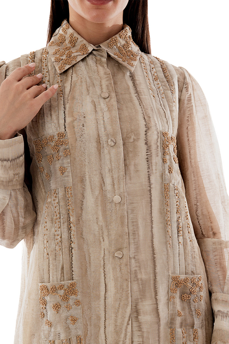 Close-up of a Shatha Essa embroidered maxi shirt dress showcasing intricate floral embroidery and detailed craftsmanship.