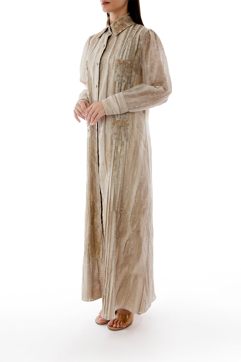 Side view of a SHATHA ESSA embroidered maxi shirt dress with detailed stitching and a relaxed fit.