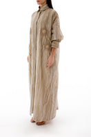 Side view of a floral embroidered oversized maxi shirt dress with an inner dress by Shatha Essa, featuring colorful embroidery and flowing fabric.