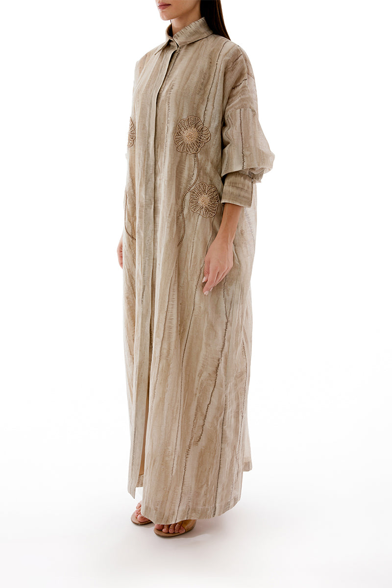 Side view of a floral embroidered oversized maxi shirt dress with an inner dress by Shatha Essa, featuring colorful embroidery and flowing fabric.