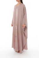 Side view of SHATHA ESSA tassel detail embellished caftan maxi dress with flowing fabric and intricate embellishments.