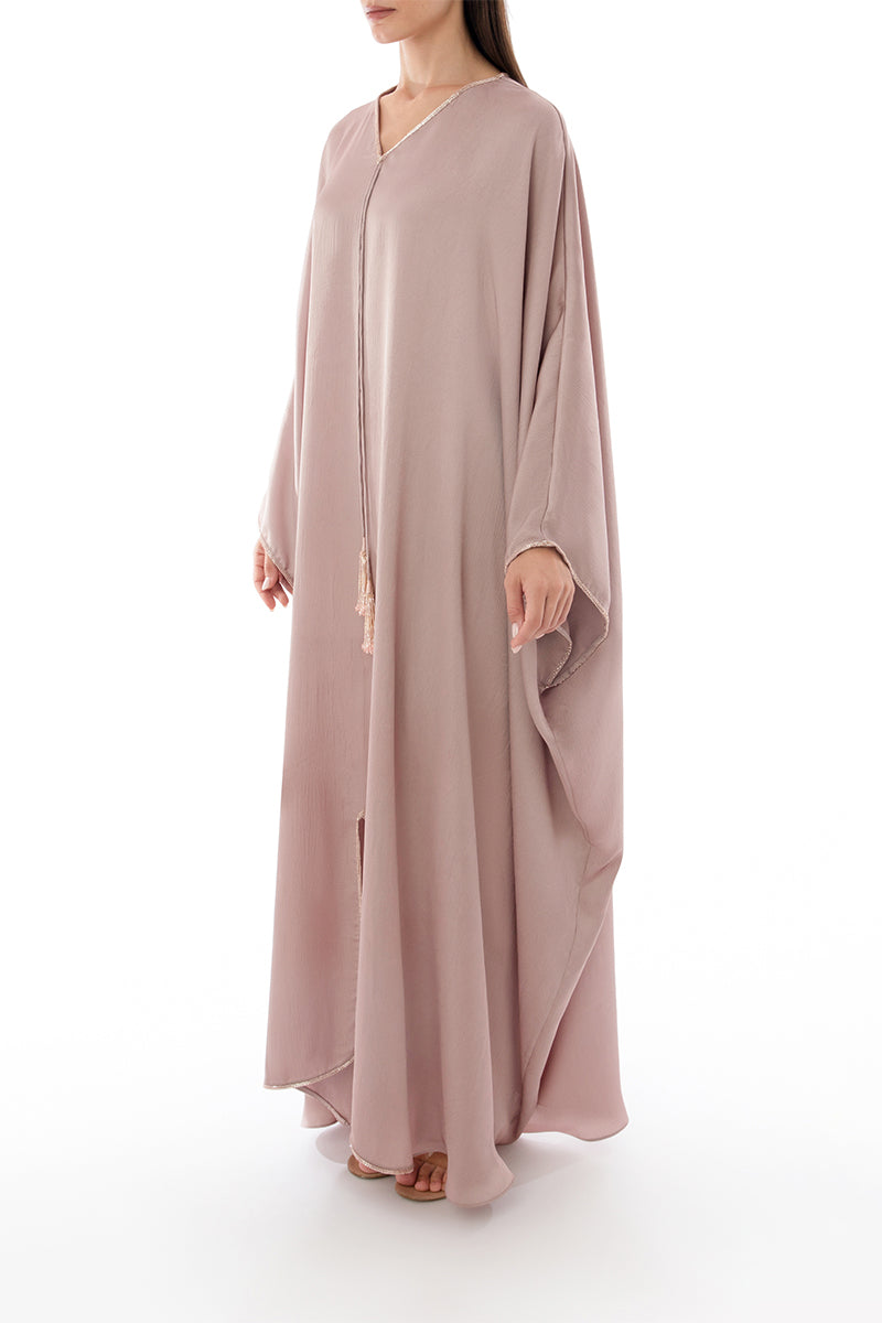 Side view of SHATHA ESSA tassel detail embellished caftan maxi dress with flowing fabric and intricate embellishments.