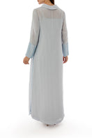 Back view of a SHATHA ESSA embroidered maxi dress with side slit detail and inner dress, showcasing elegant embroidery and flowing fabric.