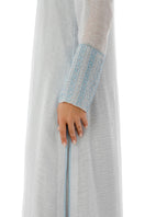Close-up of a SHATHA ESSA embroidered maxi dress with side slit detail and inner dress, showcasing intricate embroidery and fabric texture.