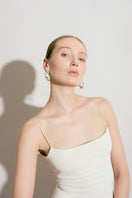 Silver Renaser earrings by Eugenia Ospina featuring sleek, minimalist design with polished silver finish.