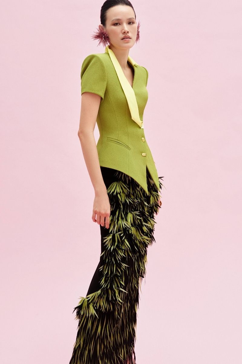 Green Jenny K Tran Retford Maxi Skirt shown on a model, flowing fabric and high-waisted design for a stylish look.
