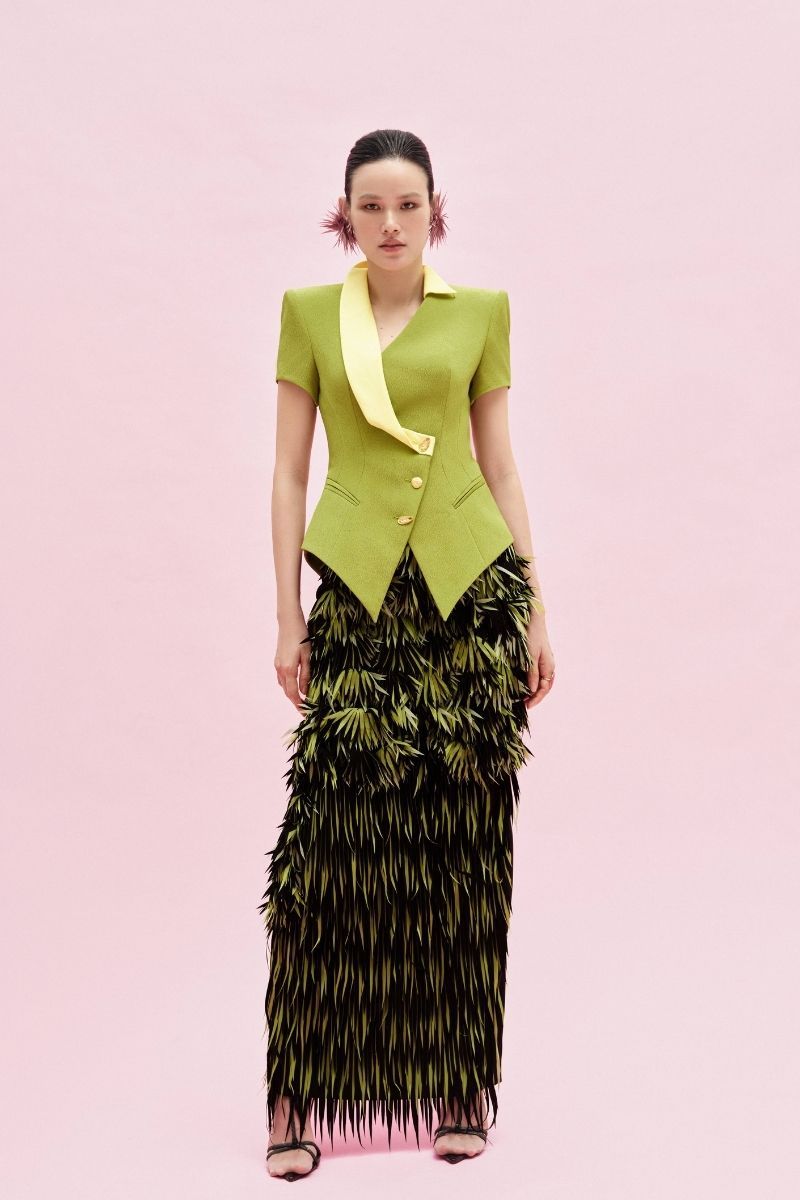 Green Jenny K Tran Retford Maxi Skirt displayed on a model, showcasing its flowy fabric and elegant design.