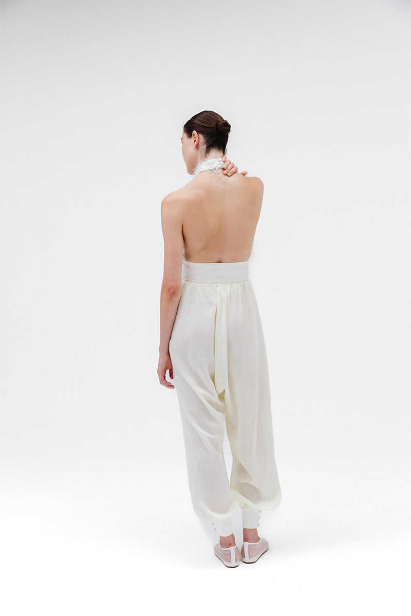 Studio NK Rianne Ivory Pants showing relaxed fit and smooth fabric, styled with a casual top for a chic everyday look.