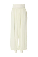 Studio NK Rianne Ivory pants featuring a relaxed fit, high waist, and lightweight fabric, shown on a model.