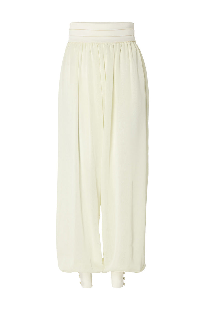 Studio NK Rianne Ivory pants featuring a relaxed fit, high waist, and lightweight fabric, shown on a model.