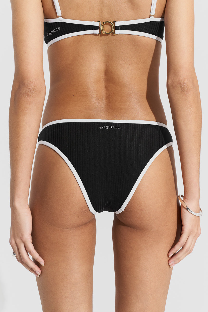 Black ribbed bikini top and bottom by Seaquelle, featuring a sleek, textured design perfect for beachwear and swim sessions.