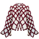 Jessica K burgundy and beige Rosa cardigan, soft knit sweater with a relaxed fit, displayed on a hanger.