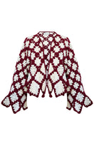 Jessica K burgundy and beige Rosa cardigan, soft knit sweater with a relaxed fit, displayed on a hanger.