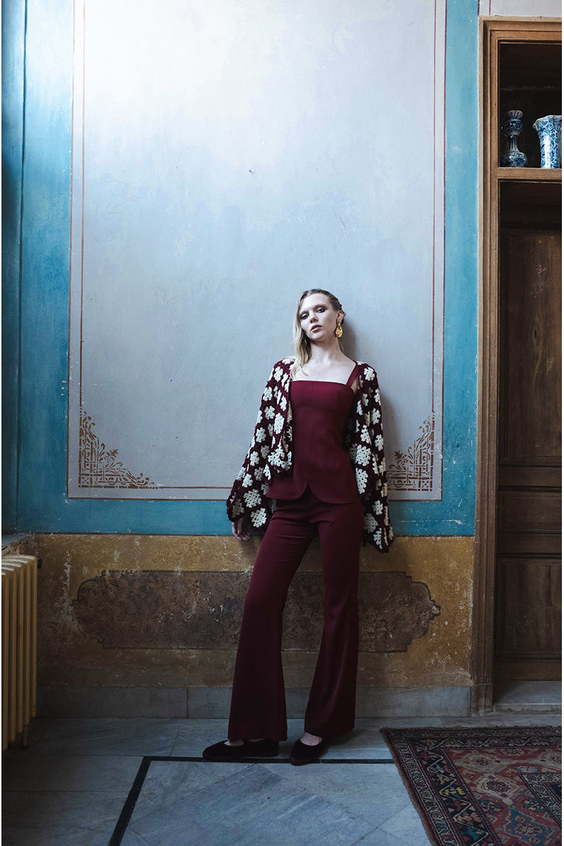 Jessica K burgundy and beige Rosa cardigan displayed on a hanger, showcasing soft knit fabric and stylish design.