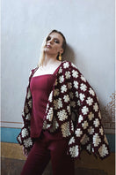 Jessica K burgundy and beige Rosa cardigan featuring a soft knit texture and a relaxed fit, displayed on a hanger.